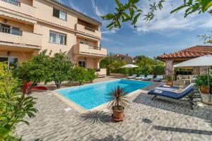 an image of a swimming pool in a house at Apartments Juric in Rab