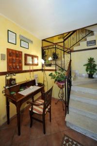 a room with a desk and a staircase with a table at Albergo Pensione Paola in Pescasseroli