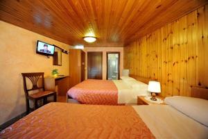 Ένα ή περισσότερα κρεβάτια σε δωμάτιο στο Albergo Pensione Paola
