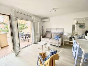 una sala de estar con un sofá y una mesa en Apartamentos Stil Mar Anna - L'Escala Stil Mar Anna Calm, en L'Escala 38 fotos más