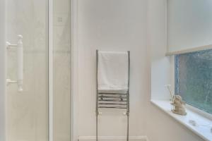 a bathroom with a mirror and a towel at The Garden Flat, Loch Lomond in Alexandria
