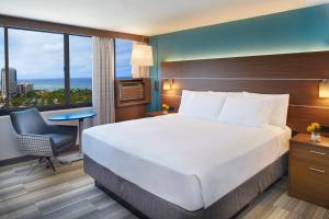 una camera d'albergo con letto, scrivania e finestra di Holiday Inn Express Waikiki, an IHG Hotel a Honolulu