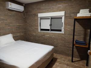 מיטה או מיטות בחדר ב-Cabañas Vista Verde