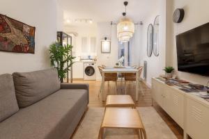 a living room with a couch and a table at Bilbao Heart 2BDR Apartment - Parking privado opcional in Bilbao
