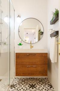 a bathroom with a mirror and a sink at Bilbao Heart 2BDR Apartment - Parking privado opcional in Bilbao +36 photos