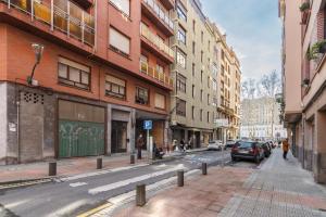 a city street with buildings and cars parked on the street at Bilbao Heart 2BDR Apartment - Parking privado opcional in Bilbao