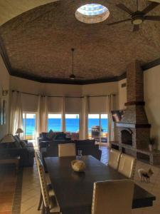 a living room with a table and a fireplace at Gorgeous Beachfront Villa Rocky point, Sandy Beach in Puerto Peñasco