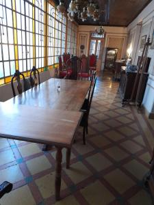 a dining room with a wooden table and chairs at La Casona in Godoy Cruz