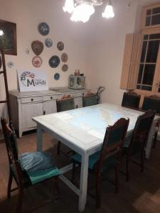 a kitchen with a table with chairs and plates on the wall at La Casona in Godoy Cruz