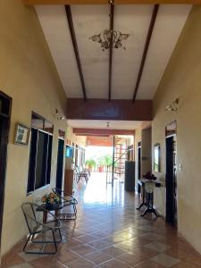 a hallway with chairs and tables in a house at Casa Glamour in Trinidad