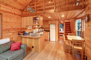 a kitchen and living room of a tiny house at Racoon Retreat in Eastsound