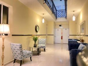 a living room with a couch and chairs and a table at RIG Casa Conde in Santo Domingo