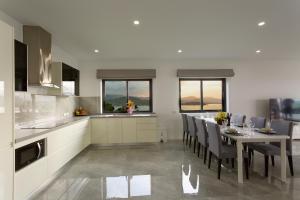 a kitchen and dining room with a table and chairs at Michael villa in Koh Samui