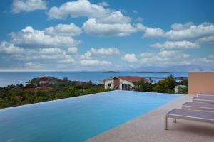 a swimming pool with a view of the ocean at Michael villa in Koh Samui