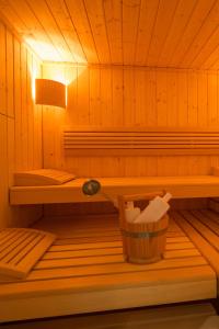a small wooden sauna with a basket in it at Monbijou Hotel in Berlin