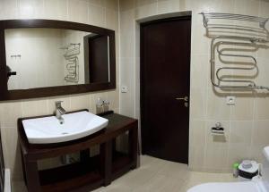 a bathroom with a sink and a mirror at комплекс гостиниц Athletic in Taraz +37 photos