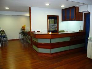 a kitchen with a bar with a counter top at Hostal Liebana in Santander