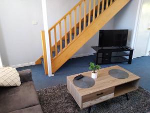 a living room with a couch and a coffee table at Cosy 2 bedroom Unit in a secure gated complex in Kalgoorlie