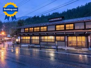 a building on the side of a street at night at Ryokan Gizan in Takayama