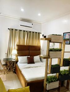 a bedroom with a bunk bed with a ladder at Cozy studio unit in lekki phase 1 - Kitchen, 24-7 light, wifi, Netflix in Lagos