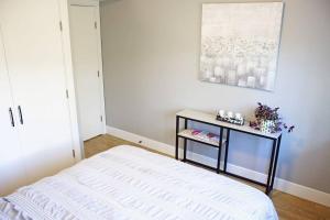 A bed or beds in a room at Next to Olympic View golf course 2 bedroom private suite