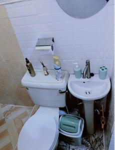 a bathroom with a toilet and a sink at Cozy studio unit in lekki phase 1 - Kitchen, 24-7 light, wifi, Netflix in Lagos