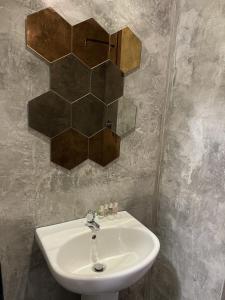 a bathroom with a sink and a mirror on the wall at masroom Hotel Kuala Lumpur in Kuala Lumpur