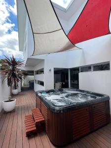a hot tub on the deck of a house at Ultra Stylish Fremantle Area in Fremantle