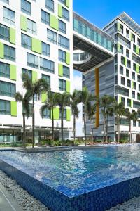 a swimming pool in front of a building at Holiday Inn & Suites Saigon Airport by IHG in Ho Chi Minh City +37 photos