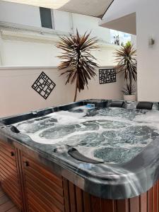 a large hot tub in a room with plants at Ultra Stylish Fremantle Area in Fremantle