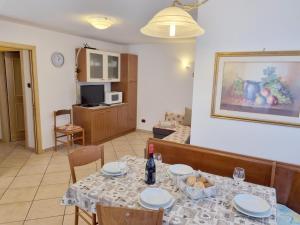 a dining room with a table with plates and wine bottles at Ciapià in Campitello di Fassa