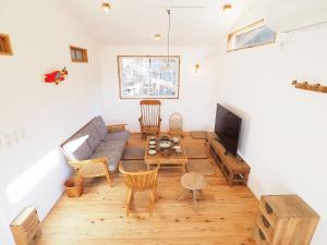 a living room with a couch and a table at とけとけ山荘 in Fujikawaguchiko