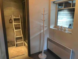 a bathroom with a shower with a pole in the corner at 'T Achterhuys in Ostend