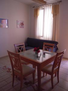 a living room with a table and chairs and a couch at Gite Muscat for 4 people in the heart of the vineyard in Badens