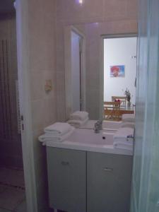 a bathroom with a sink and a mirror at Gite Muscat for 4 people in the heart of the vineyard in Badens