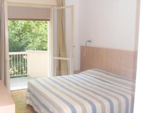 Postel nebo postele na pokoji v ubytování Hotel Enrica