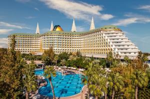 a large hotel with a pool and palm trees at Delphin Imperial Lara in Lara