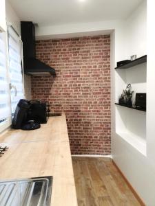 a kitchen with a brick wall and a counter at CHIC & WORK in Albert