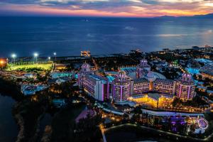 an aerial view of a city at night at Delphin BE Grand Resort in Lara