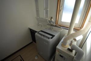a room with a washing machine and a window at Tarochan House in Engaru +41 photos