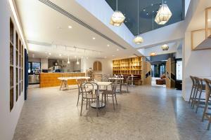 a dining room with tables and chairs and a kitchen at Avantgarde Urban Sisli in Istanbul