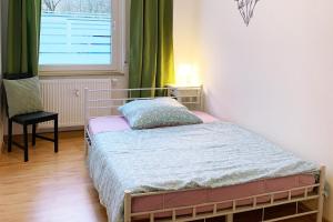 a small bedroom with a bed and a window at 3 room holiday flat in Hemer