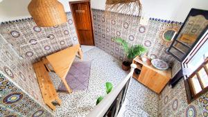 an overhead view of a room with a patterned wall at Kekai Surf House in Taghazout