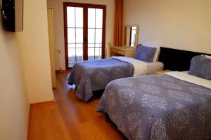 A bed or beds in a room at Miletus Otel Şile