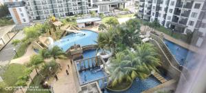 an overhead view of a swimming pool in a resort at Pool view + water theme park @swiss garden residence in Kuantan +11 photos