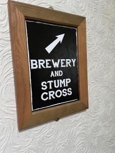 a sign that says brewery and stump cross on a wall at The Castle Tavern in Richmond