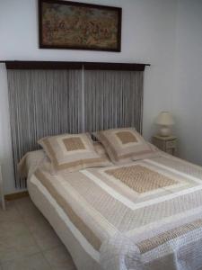 a bedroom with a large bed with a picture above it at Gite Syrah for 6 people in the heart of the vineyard in Badens