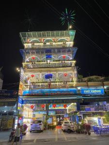 a large building with lights on it at night at Ph&uacute; Th&ocirc;ng in Chau Doc