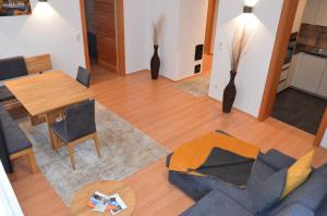 a living room with a couch and a table and chairs at Apart Anna in Pfunds
