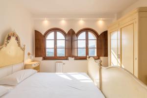 En eller flere senger på et rom på Residence Villa il Casale - appartamenti wellness e piscina riscaldata